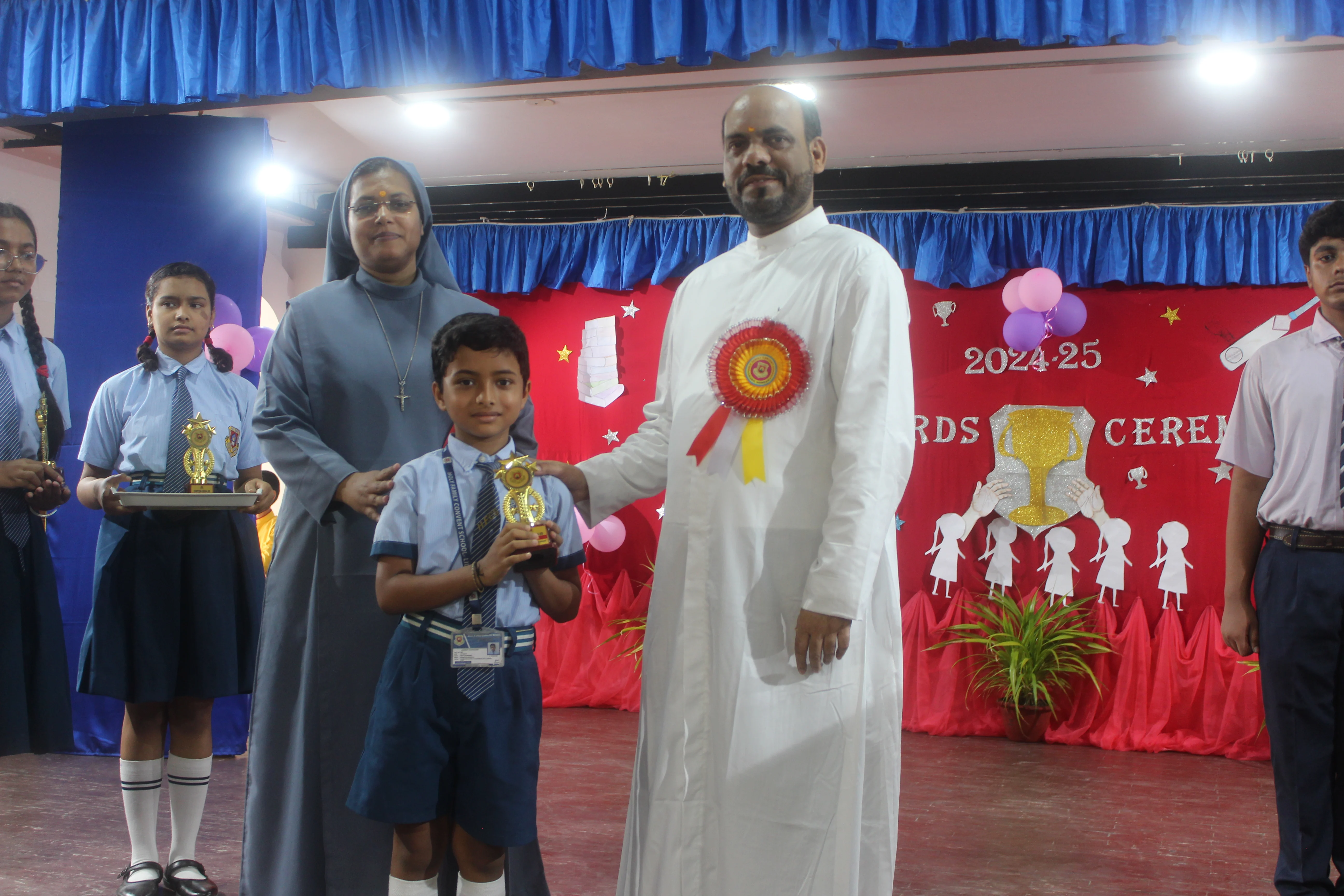 Students receiving certificates at Award Function 2025 Holy Family Convent School